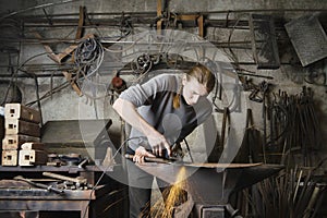 Blacksmith Working In Workshop