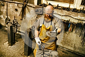 Blacksmith working in workshop