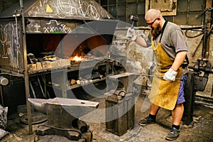 Blacksmith working in workshop