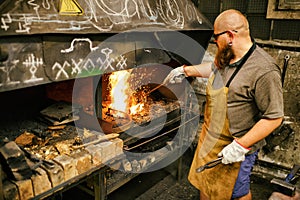 Blacksmith working in workshop