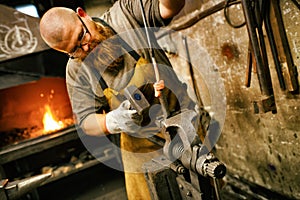 Blacksmith working in workshop