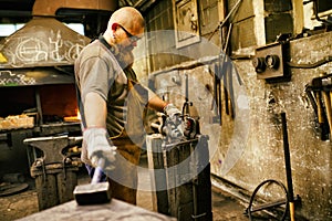 Blacksmith working in workshop