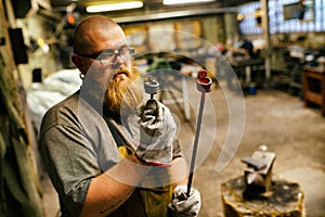 Blacksmith working in workshop