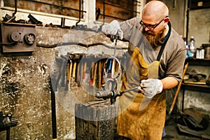 Blacksmith working in workshop