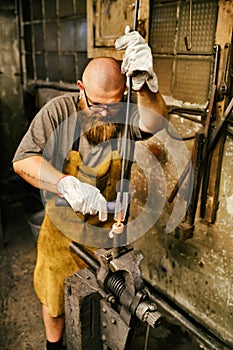 Blacksmith working in workshop