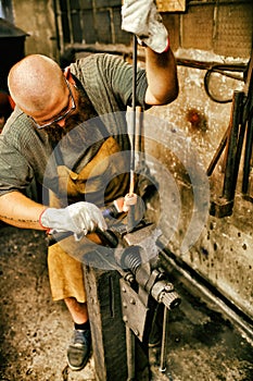 Blacksmith working in workshop