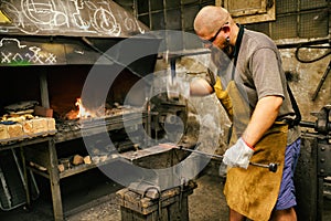 Blacksmith working in workshop