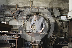 Blacksmith Working In Workshop