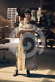 Blacksmith, workshop and portrait of woman with crossed arms for industry, manufacturing and welding. Industrial factory