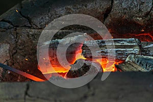 Blacksmithing, a red-hot piece of iron in a forge furnace