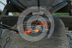 Blacksmithing, a red-hot piece of iron in a forge furnace