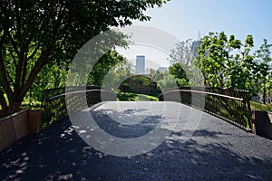 Blacktopped arch bridge in sunny summer morning photo