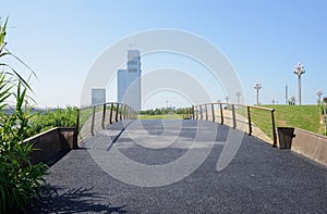 Blacktopped arch bridge in sunny summer morning photo