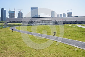 Blacktopped path on grassy lawn before TICC in sunny summer photo