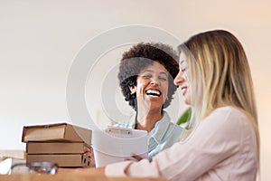 Blackwoman laughing while working at warehouse photo