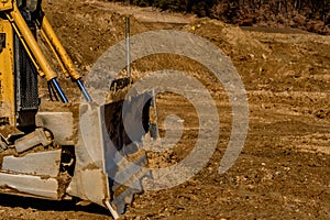 Blade and hydraulic lift cylinders of bulldozer at new construction site