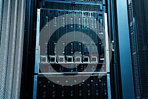 Blade server close-up in series of mainframes in modern data center. Blue tone