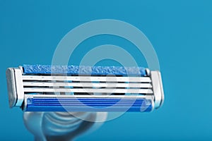 Blades of a new shaving machine on a blue background