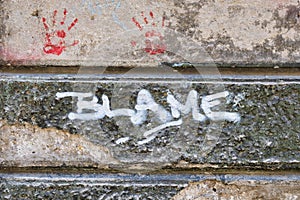 Blame Graffiti on Old Stone Wall