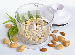 Blanched almonds In a blender with unshelled nuts. On white back