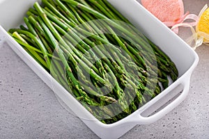 Blanched young asparagus in a baking pan