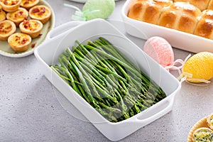 Blanched young asparagus in a baking pan