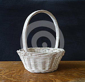 Blanching basket braided from twig on wooden table