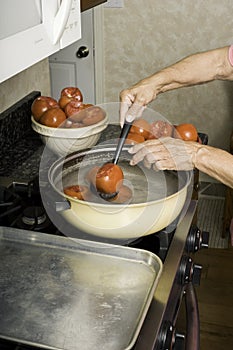 Blanching tomatoes for canning.