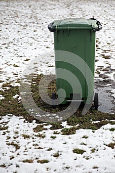 Blank ad space trash can standing in a picnic field in Winter photo