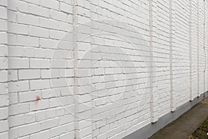 Blank ad space on a white brick wall in the street outside