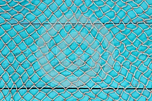 Blank antique teal blue aged wooden sign with fish net texture overlay