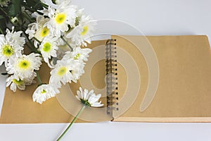 Blank area note book or diary with flower