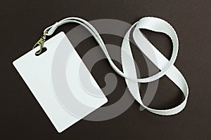 Blank badge or ID pass isolated on brown background, clipping path included photo