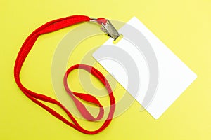 Blank badge mockup isolated on yellow background. Plain empty name tag mock up with red string