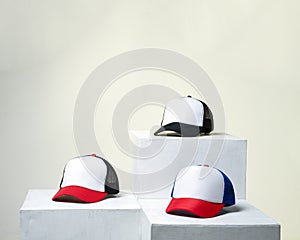 Blank baseball cap neatly displayed on a tiered stand.