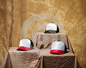Blank baseball cap neatly displayed on a tiered stand.