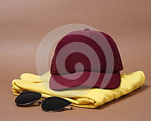 Blank baseball caps are used for design mockups. The hat on the side of an old camera and sunglasses.