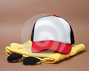 Blank baseball caps are used for design mockups. The hat on the side of an old camera and sunglasses.