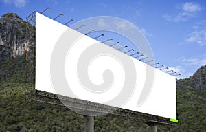 Blank big billboard against green mountain and blue sky background,for your advertising,put your own text here