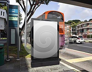 Blank billboard mock up at a bus stop with busy traffic in Singapore