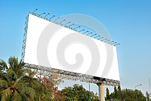 Blank billboard mockup with white screen against clouds and blue sky background. Copy space banner for advertisement.