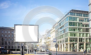 Empty billboard for public advertisement on the roadside. Space for text. People and city background