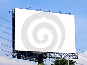 Blank billboard with white screen against clouds and blue sky background.