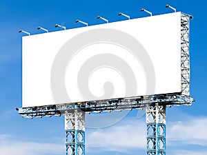 Blank billboard with white screen against clouds and blue sky background. Copy space banner for advertisement.