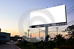 Blank billboard with white screen against clouds and blue sky background. Copy space banner for advertisement.