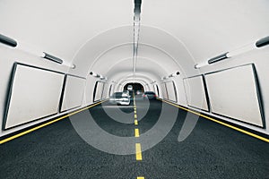 Blank billboards inside the tunnel with cars