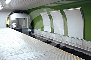 Blank billboards and moving train in subway