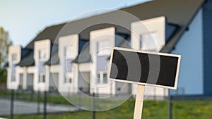 Blank Black billboard against apartment family house Empty mockup template Blackboard label at Townhome. Copy space