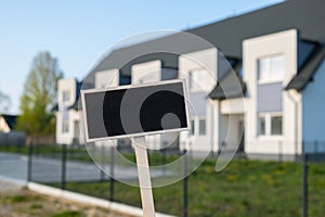 Blank Black billboard against apartment family house Empty mockup template Blackboard label at Townhome. Copy space