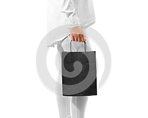 Blank black craft textured paper bag mockup holding hand
